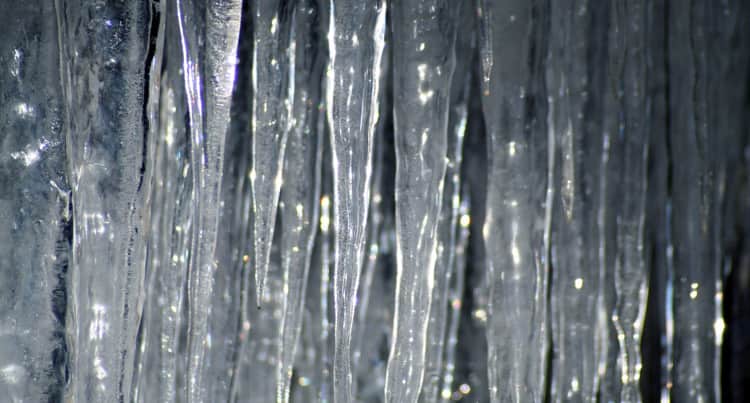 photo of icicles hanging off of a roof