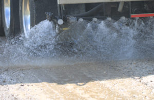 Photo of a great lakes chloride truck spraying dust control product
