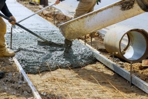 Speed up concrete curing times with Ohio Concrete Accelerator solutions image shows workers pouring concrete