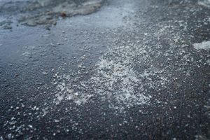 Utilize calcium chloride as an Ohio Road Salt Alternative image shows salt on icy ground