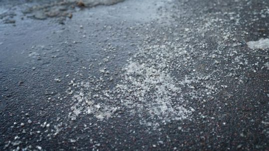 Utilize calcium chloride as an Ohio Road Salt Alternative image shows salt on icy ground