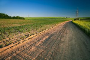 Handle Ohio Dirt Road Stabilization with calcium chloride products from Great Lakes Chloride image shows rural dirt road