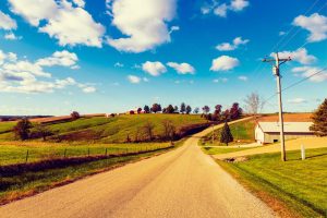 Use calcium chloride from Great Lakes Chloride for Indiana Road Base Stabilization image shows gravel road in rural area