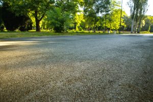 Handle Indiana Road Base Stabilization with help from Great Lakes Chloride image shows gravel lot next to trees